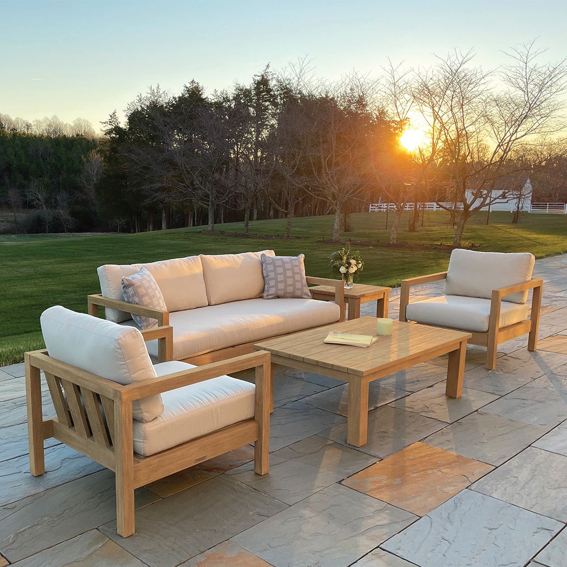 The Montauk Lounge Chair combines coastal style with exceptional durability. Its extra-deep seat and distressed teak construction create a relaxed aesthetic while standing up to diverse weather conditions including salt air, rain, and snow. - alternate view
