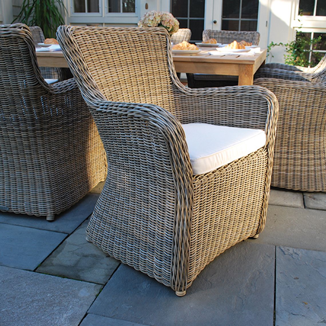 The Sag Harbor Dining Armchair brings relaxed coastal elegance to outdoor dining with its extra-large wicker weave and comfortable proportions. Built to withstand direct sun, rain, poolside conditions, and salt air. - alternate view