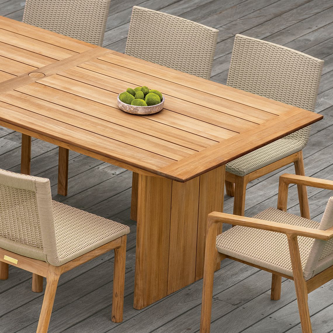 The Cortona 108" dining table combines refined elegance with weather-resistant durability. Crafted from solid Grade A teak, it offers generous seating for 8-10 guests and includes an umbrella hole for shade. - alternate view