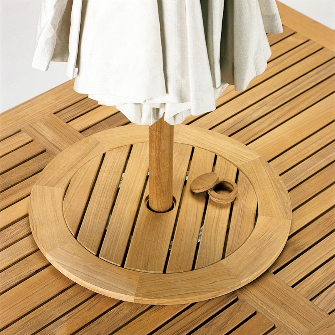 This 25-inch rotating lazy susan brings functional elegance to outdoor dining with Grade A teak construction and weather-resistant aluminum hardware. The integrated umbrella hole adds versatility for shaded dining. - alternate view