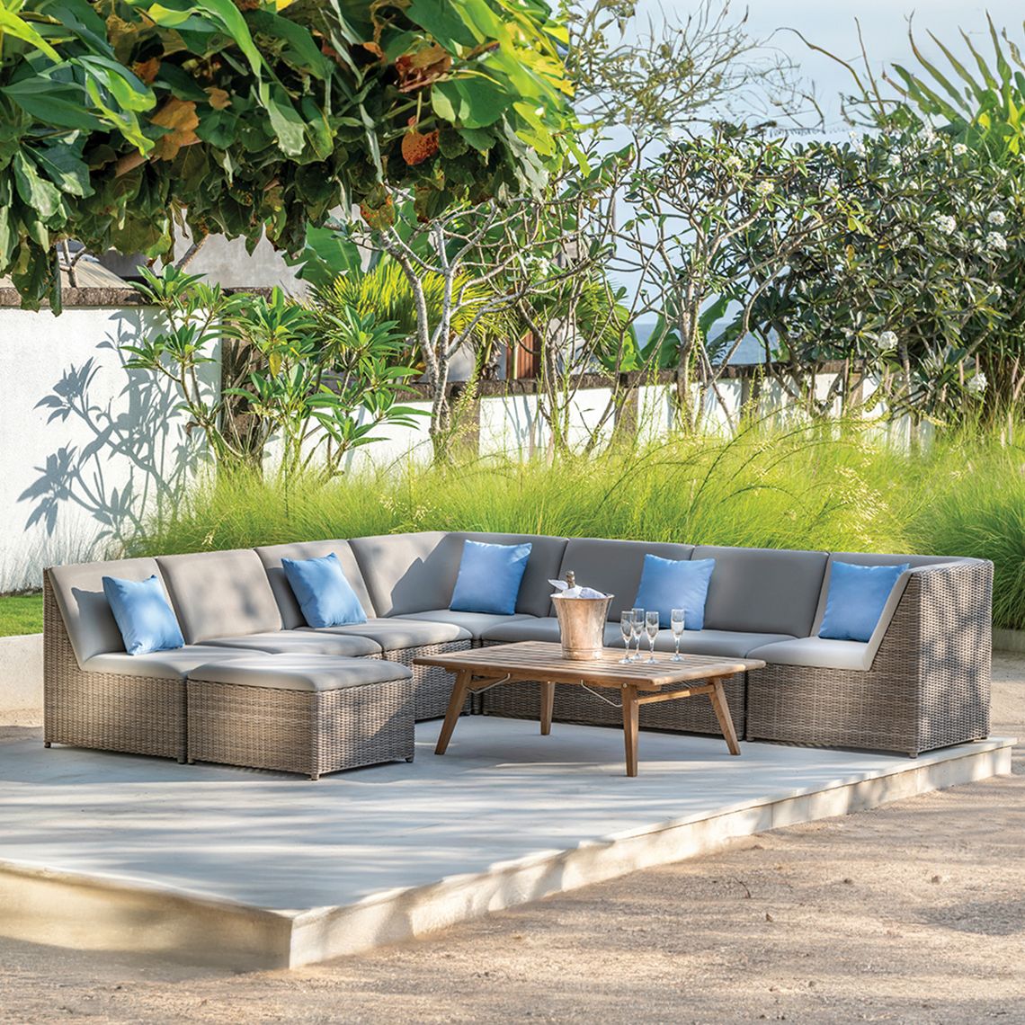 The Milano Sectional Ottoman combines hand-woven all-weather wicker with contemporary upholstered sling seating. Its compact 27-inch square footprint and modular design make it ideal for flexible outdoor seating arrangements. - alternate view