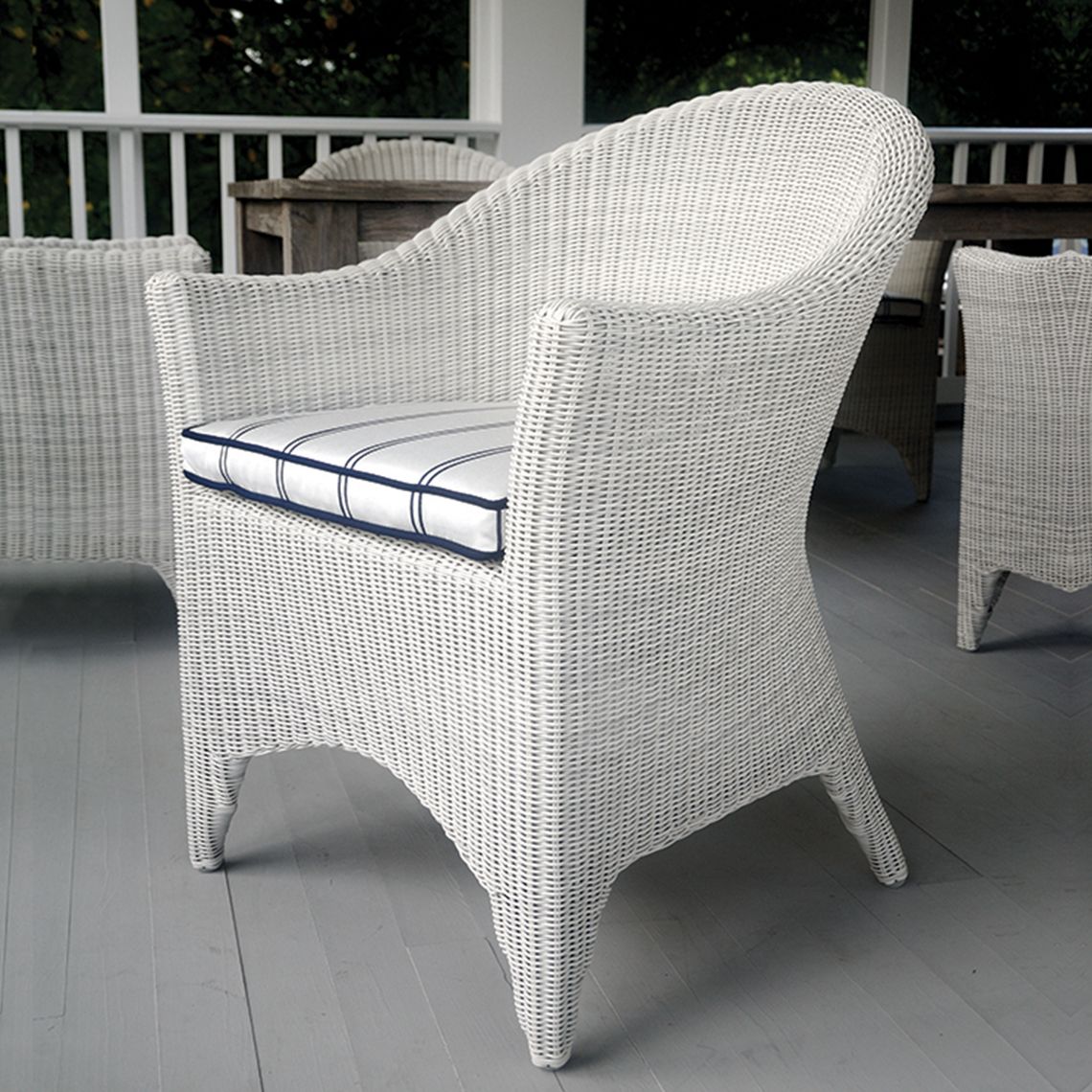 A timeless porch-style dining armchair that brings traditional wicker charm to outdoor spaces. Hand-woven construction withstands direct sun, rain, poolside conditions, and salt air. - alternate view