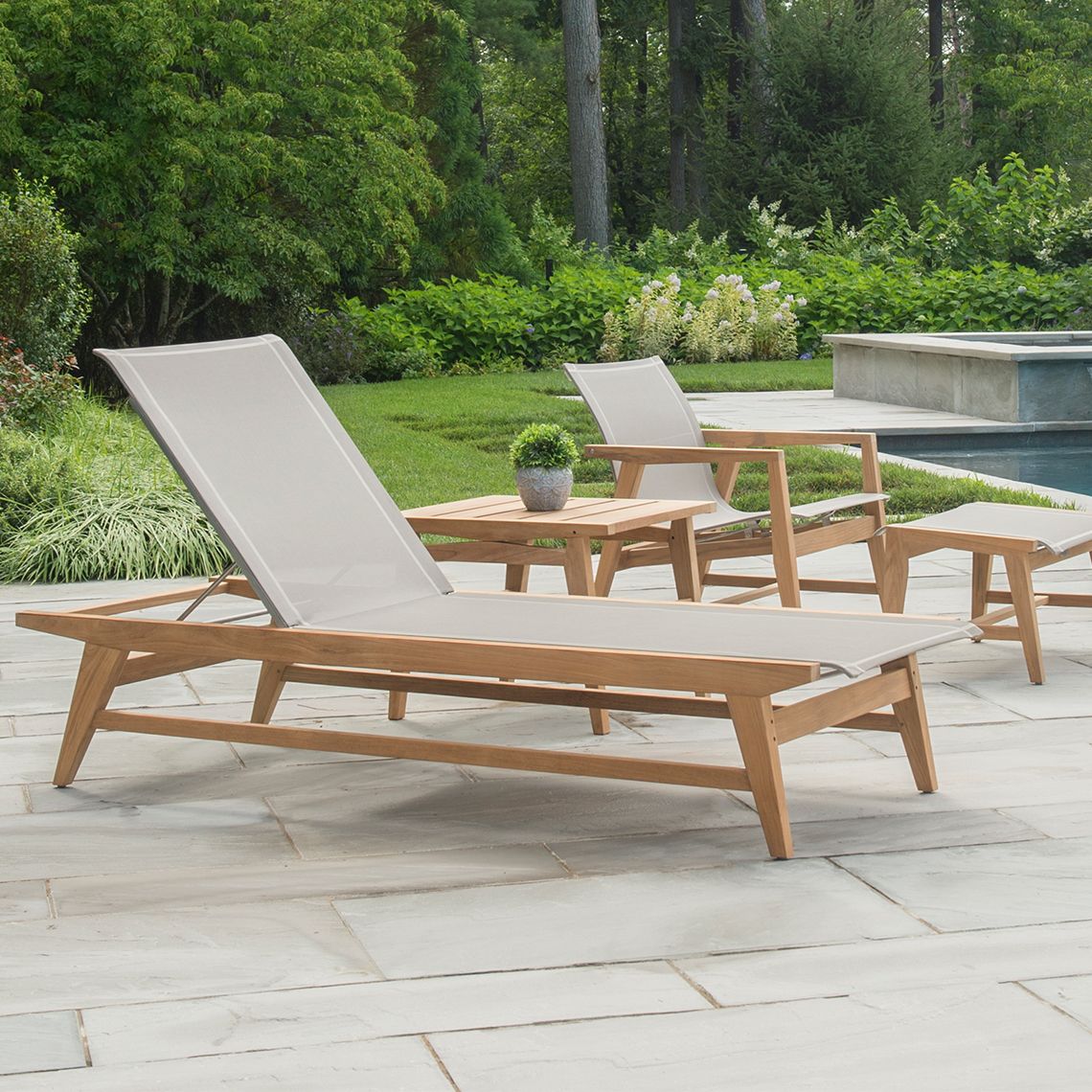 A beautifully crafted outdoor chaise featuring Grade A teak construction with Danish modern styling. The 5-position adjustable backrest and Batyline sling surface offer exceptional comfort and durability for poolside or patio relaxation. - alternate view