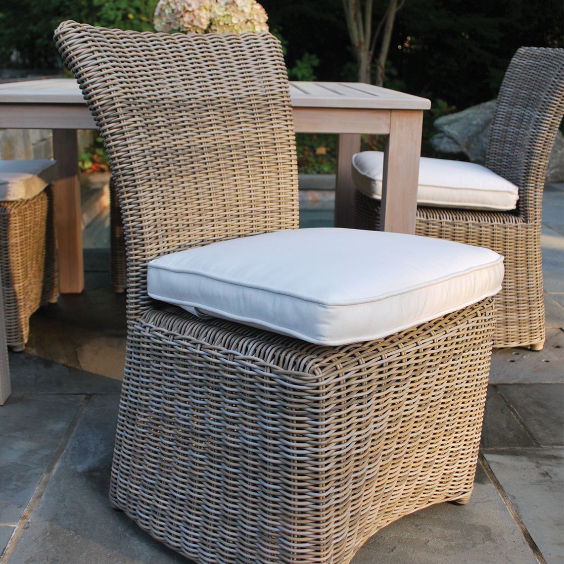 The Sag Harbor dining chair brings coastal elegance to outdoor dining with its extra-large hand-woven wicker weave. Built to withstand direct sun, rain, poolside conditions, and salt air, this chair combines resort-style aesthetics with practical durability. - alternate view