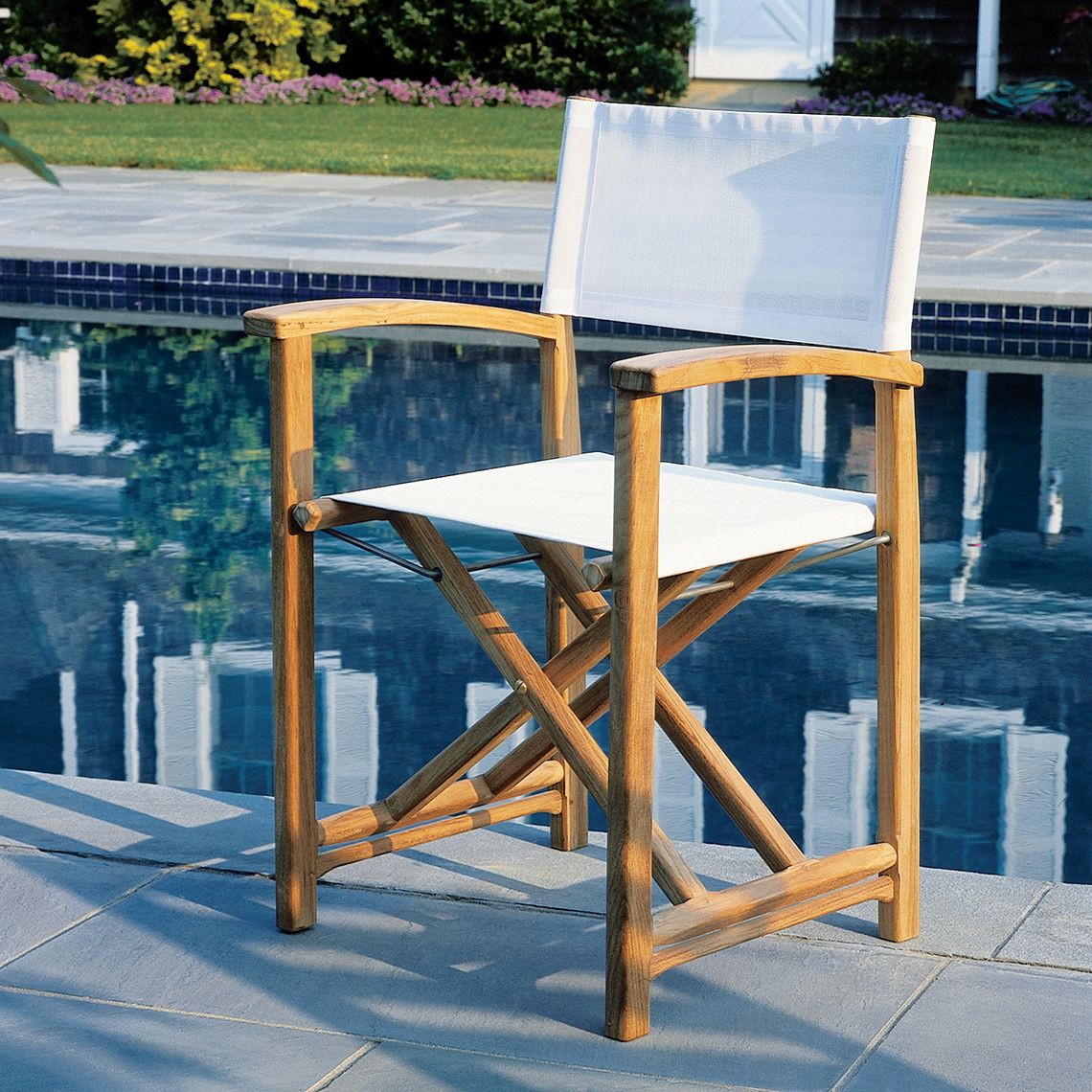 A refined folding chair crafted from Grade A teak with Phifertex sling seating. Combines classic director's chair styling with premium outdoor materials. Folds flat for convenient storage between gatherings. - alternate view