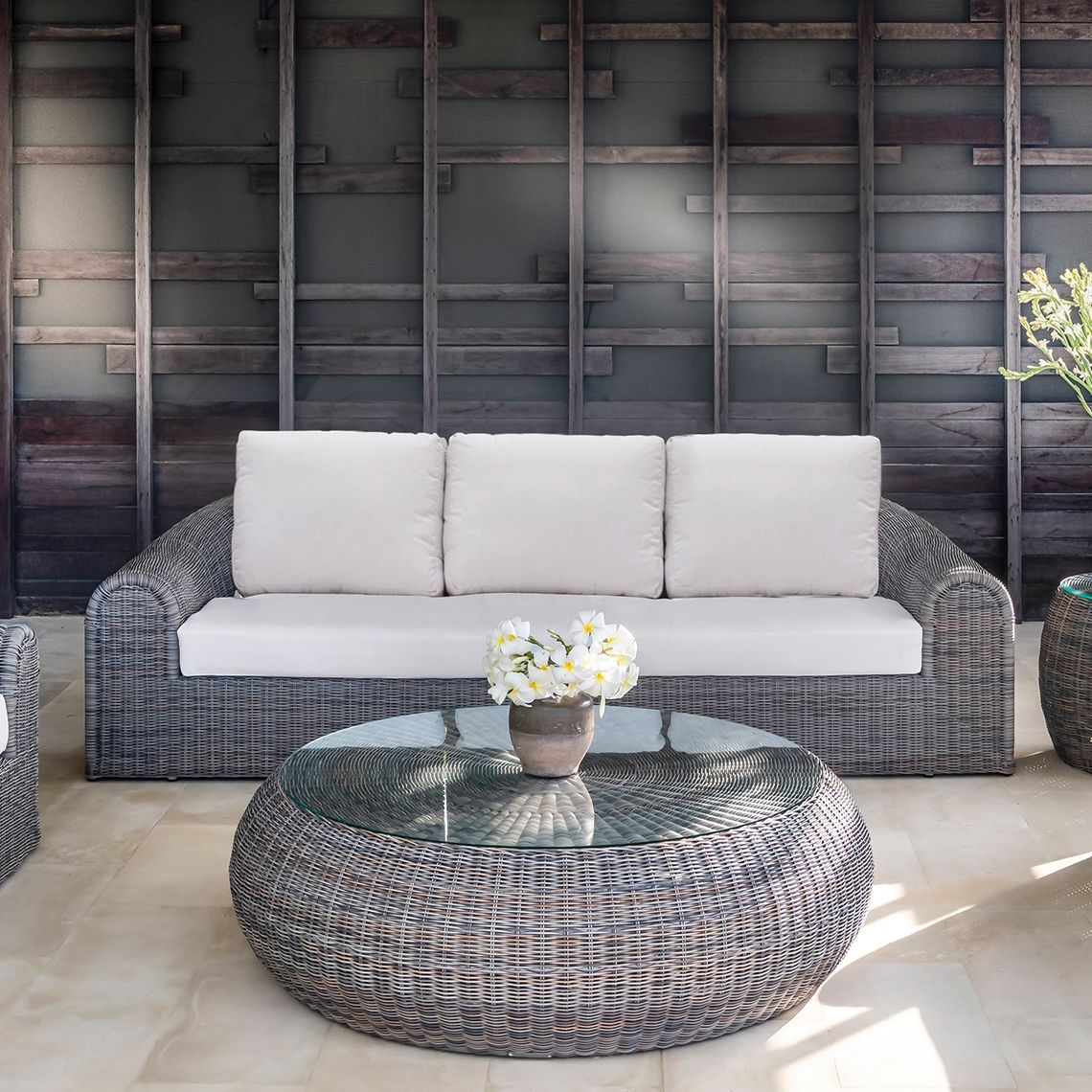 The Ojai Coffee Table brings vintage California charm to outdoor spaces with hand-woven all-weather wicker over aluminum frames. Its generous 50-inch diameter and tempered glass top make it both stylish and practical for poolside entertaining. - alternate view