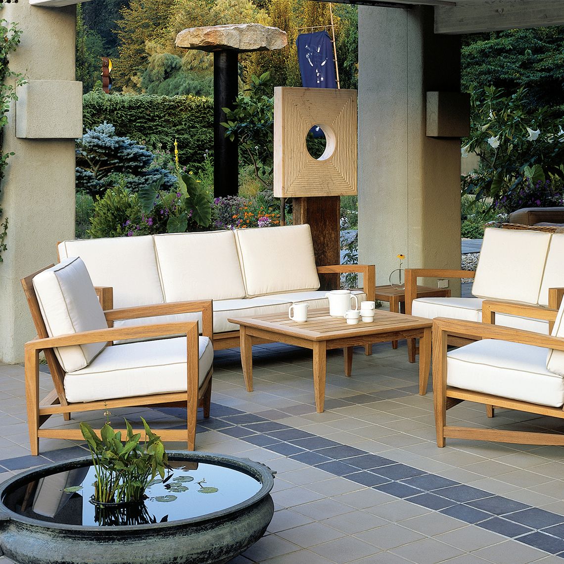 The Amalfi Sofa combines premium Grade A teak construction with contemporary angular design. Built to withstand diverse weather conditions including salt-air, rain, and snow, this substantial piece offers both durability and sophisticated style. - alternate view