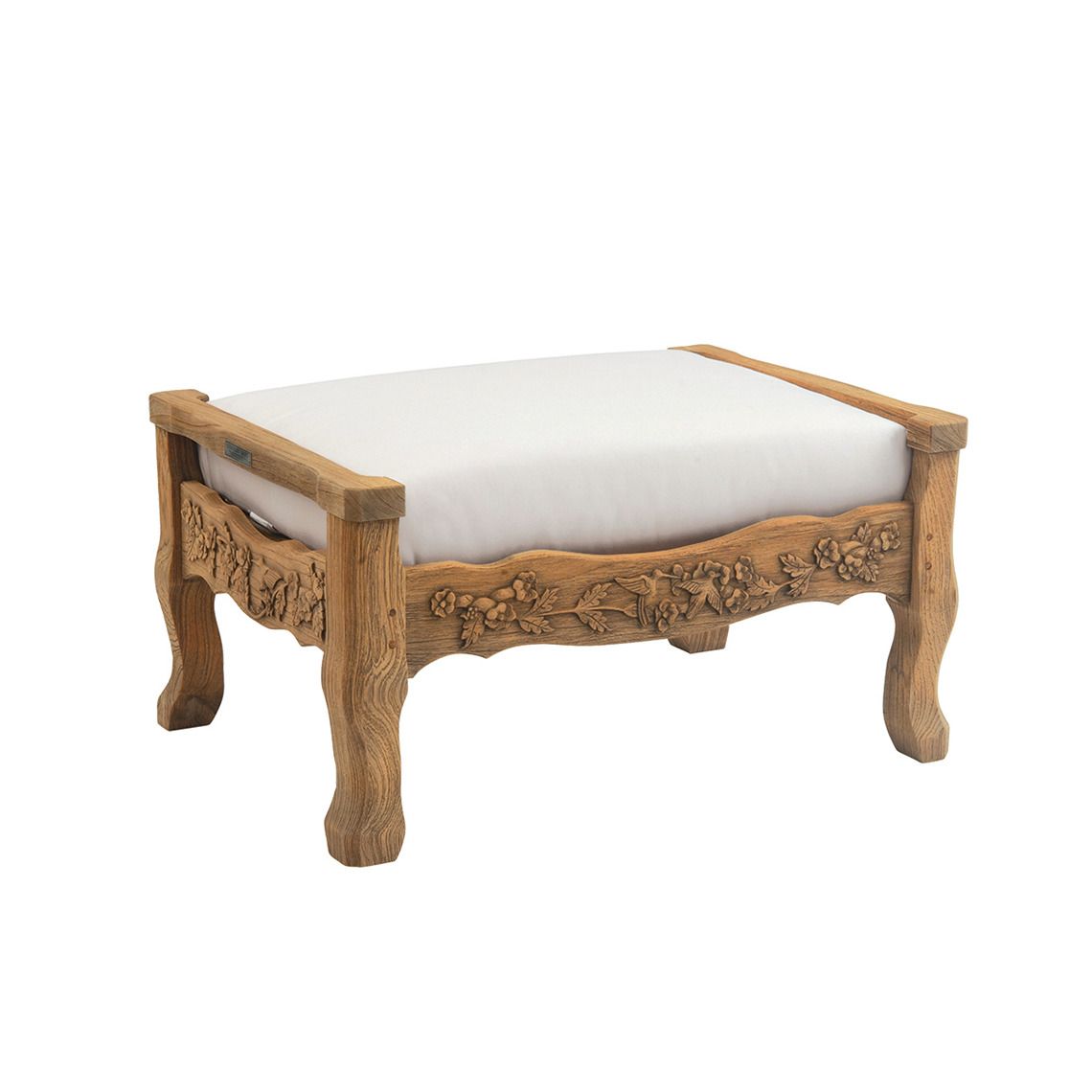The Normandy Ottoman showcases exceptional craftsmanship with hand-carved hummingbird and trumpet vine reliefs in distressed teak. Built for all-weather durability including salt-air, rain, and snow exposure.